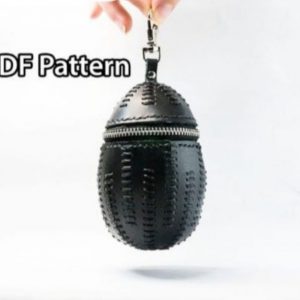 Выкройка кожаного аксессуара в форме яйца на молнии для монет или наушников.